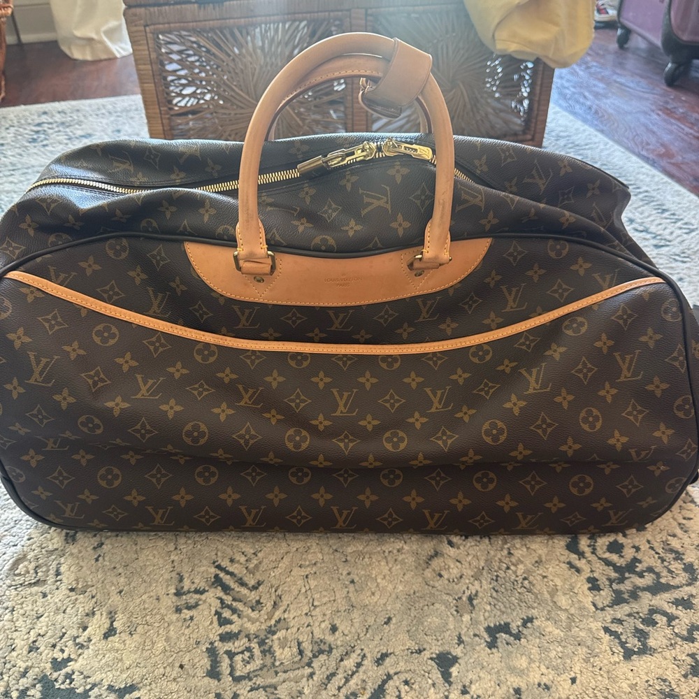 Louis Vuitton canvas rolling duffle bag, gently used.